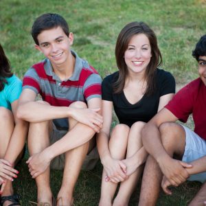 A,Group,Of,Happy,Multi-ethnic,Teenagers,Outside,On,Grass
